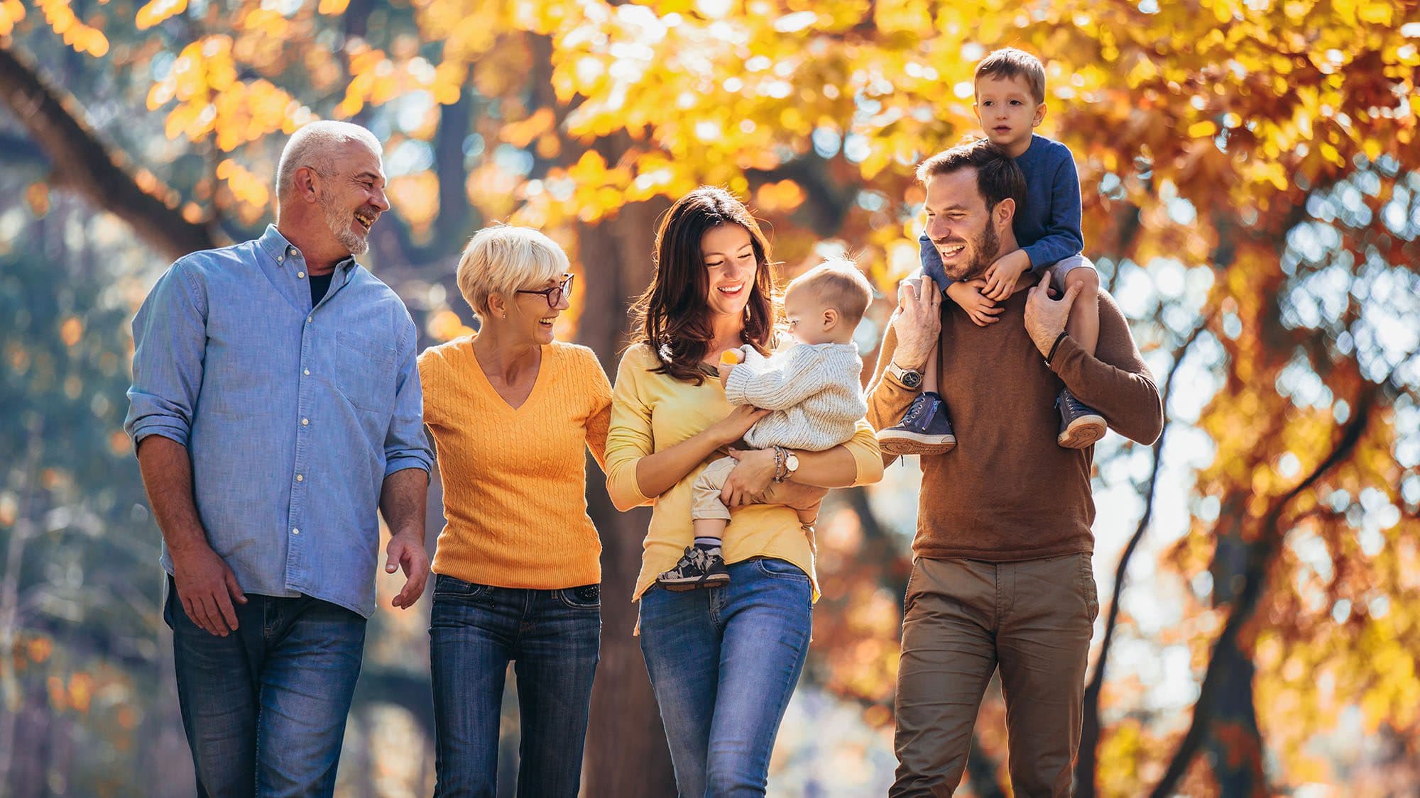 Multl generation family in autumn park having fun