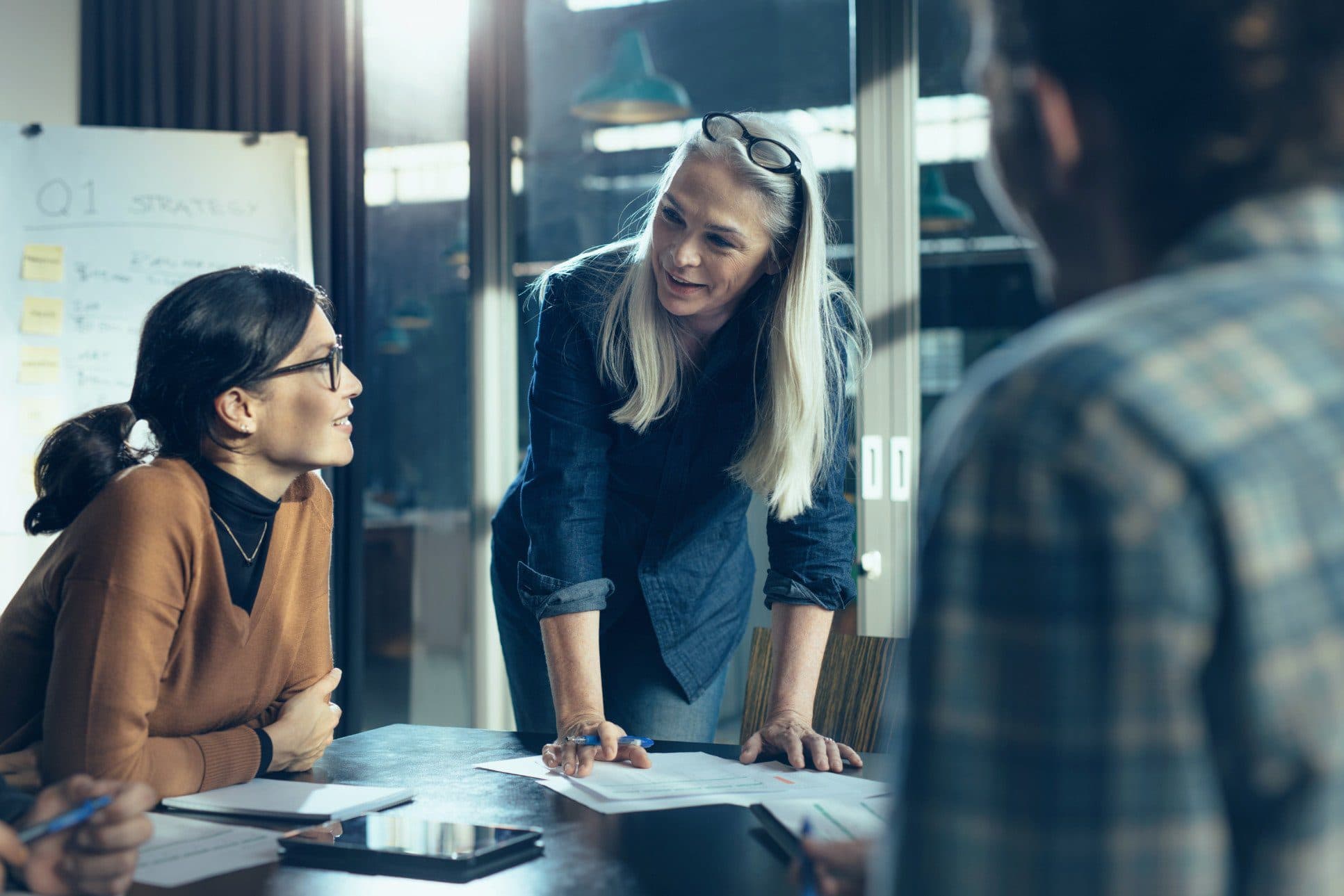Group of coworkers discussing work in casual setting
