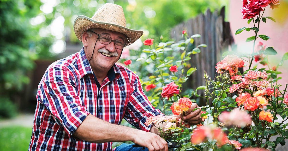 Man pauses gardening to hear facts about RMDs