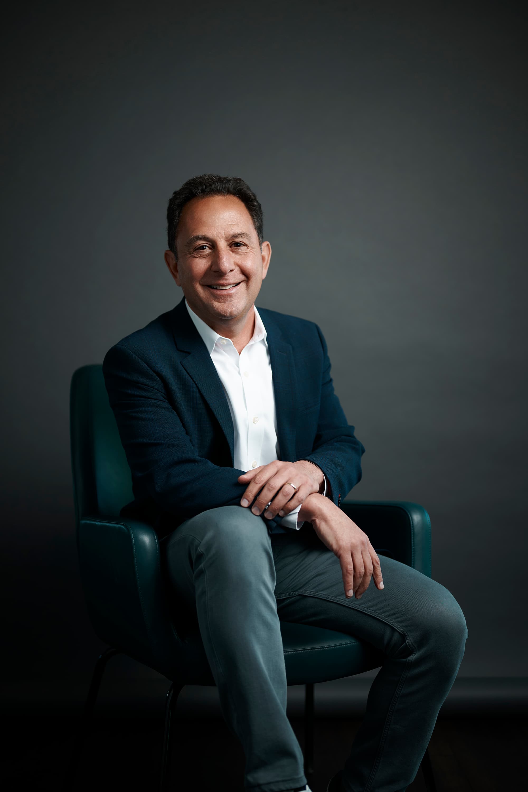 Peter Mallouk in business casual attire smiling at the camera.