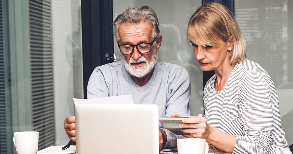 Couple reviewing documents at table