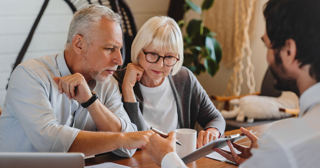Financial advisor explaining documents to couple