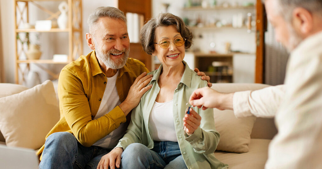Older couple receiving keys to new home