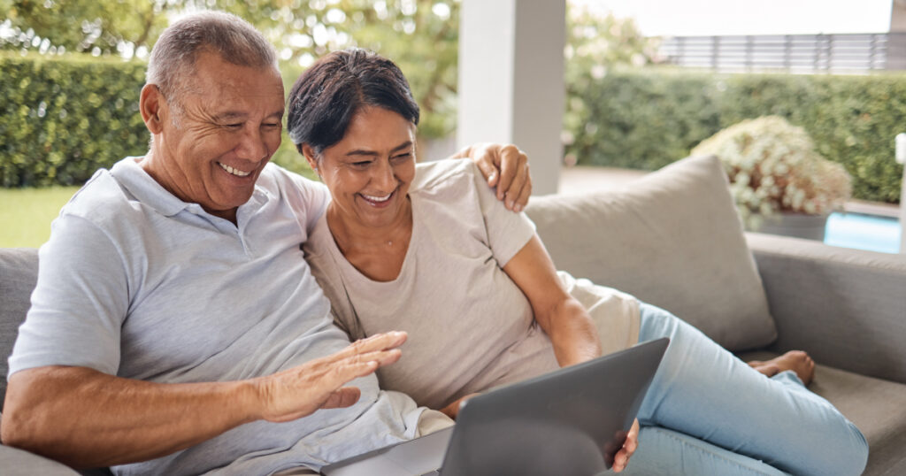 older couple researching on laptop