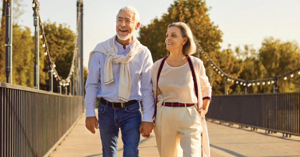 Older couple walking in city