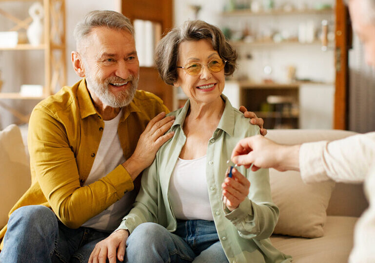Older couple receiving keys to new home