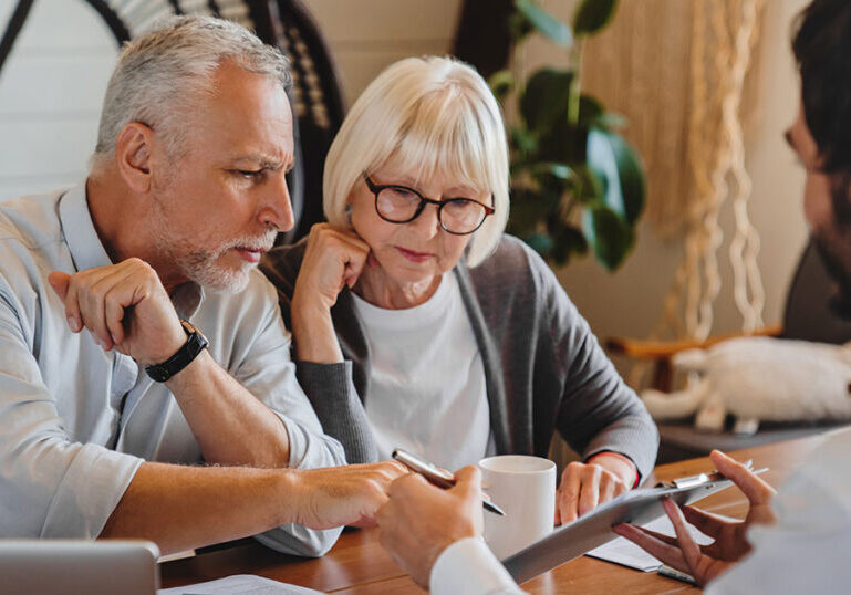 Financial advisor explaining documents to couple