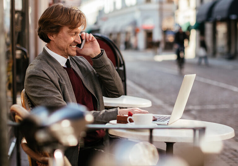 man working outside coffee shop