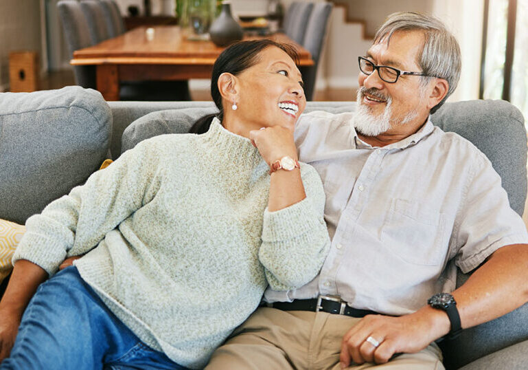 Happy senior couple sitting on a sofa.