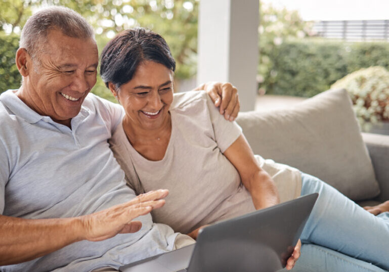 older couple researching on laptop