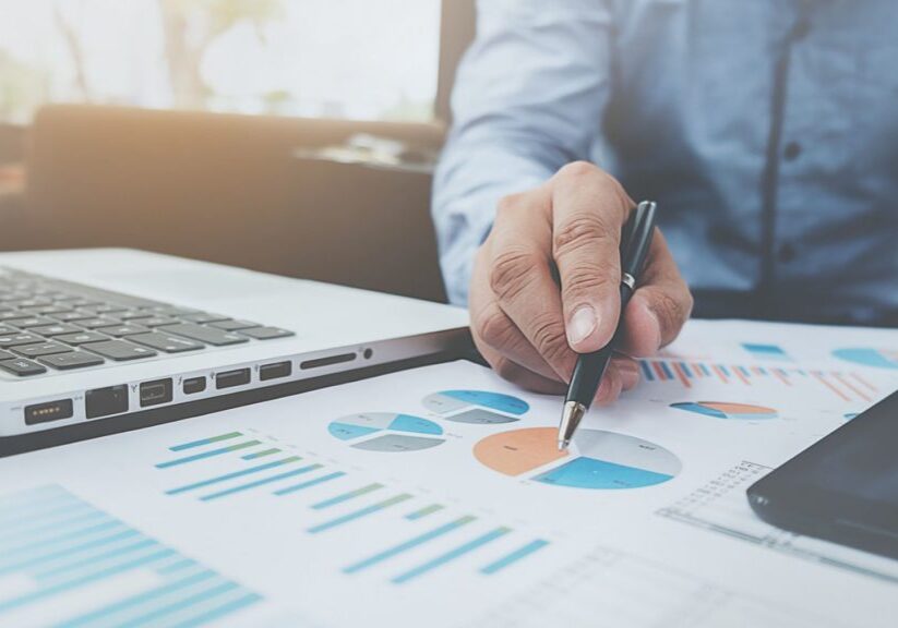 Man analyzing reports on desk