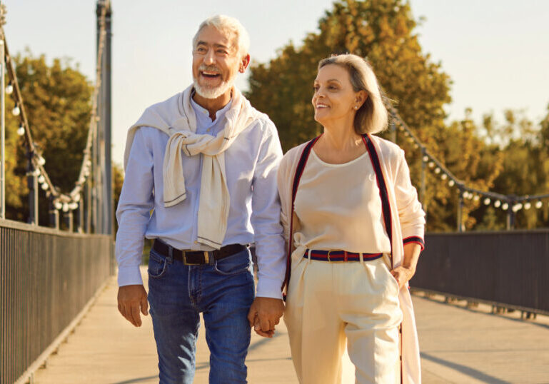 Older couple walking in city