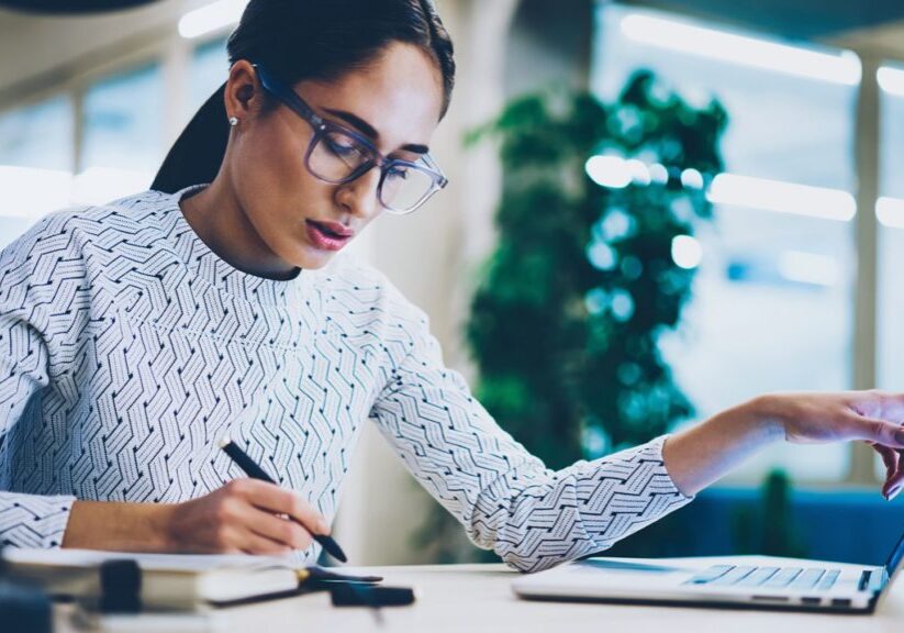 Woman reviewing data on laptop