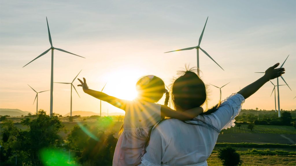 Woman and child viewing energy windmills