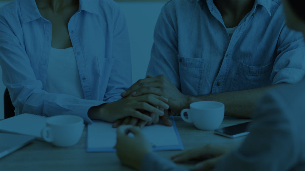 Couple reviewing documents with financial planner