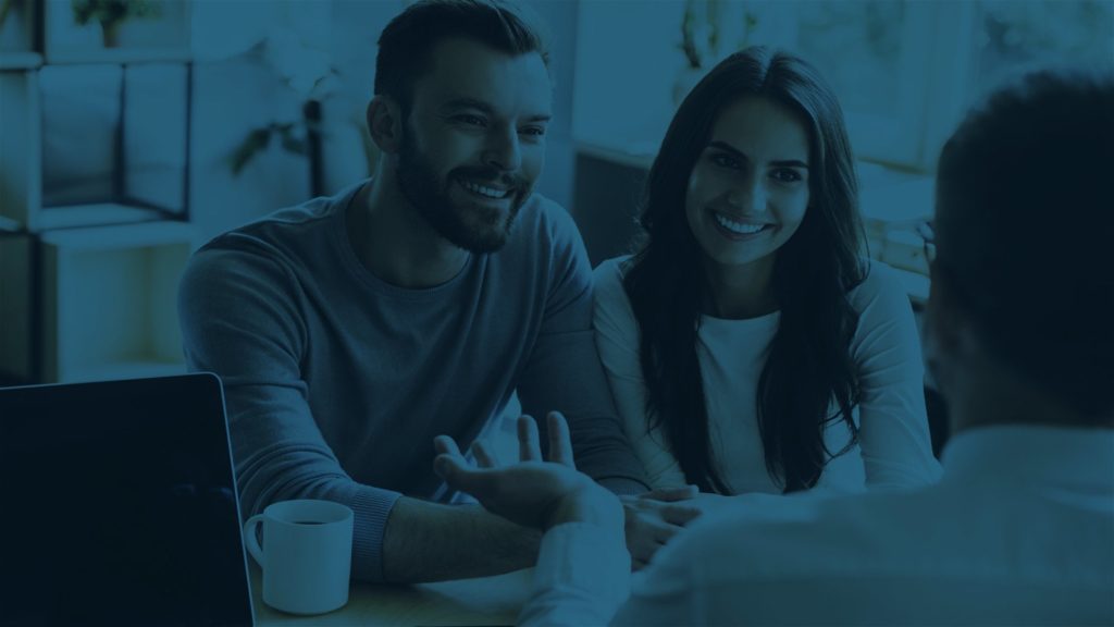 Man and woman talking to planner