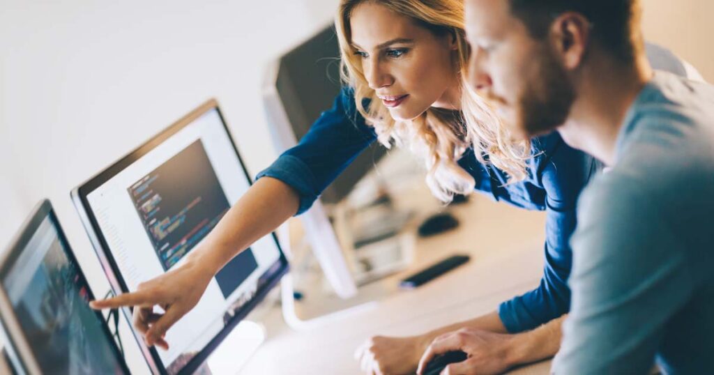 Coworkers discussing data over a computer
