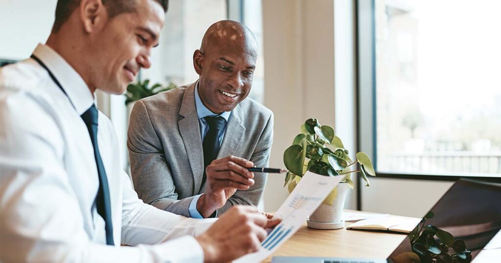 two coworkers analyzing accounting data in the office.