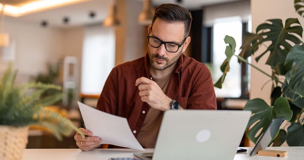 business owner analyzing tax documents at his desk
