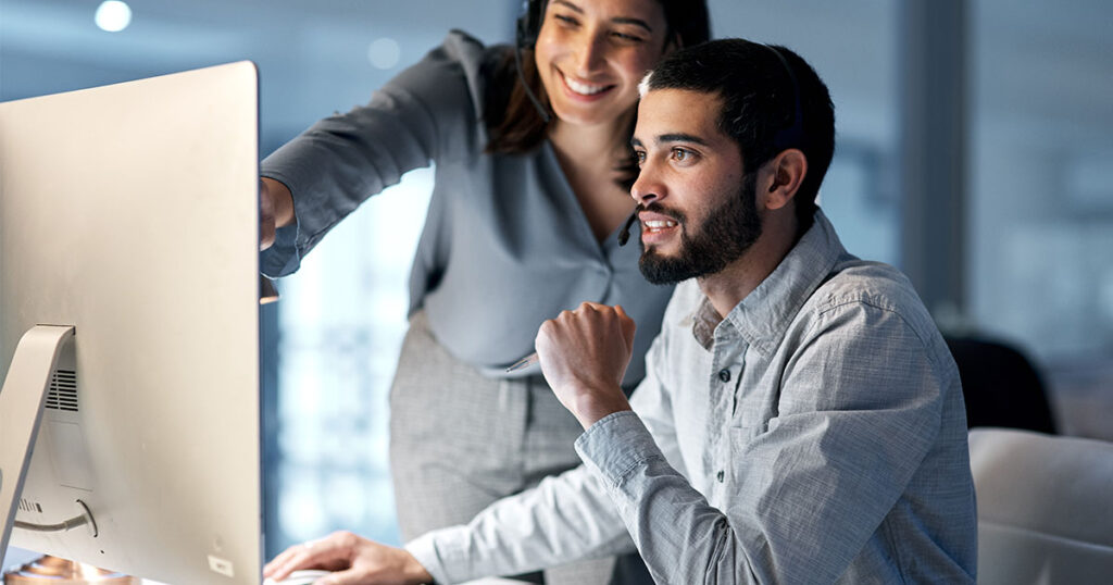 IT provider assisting client with technology issue at his desk