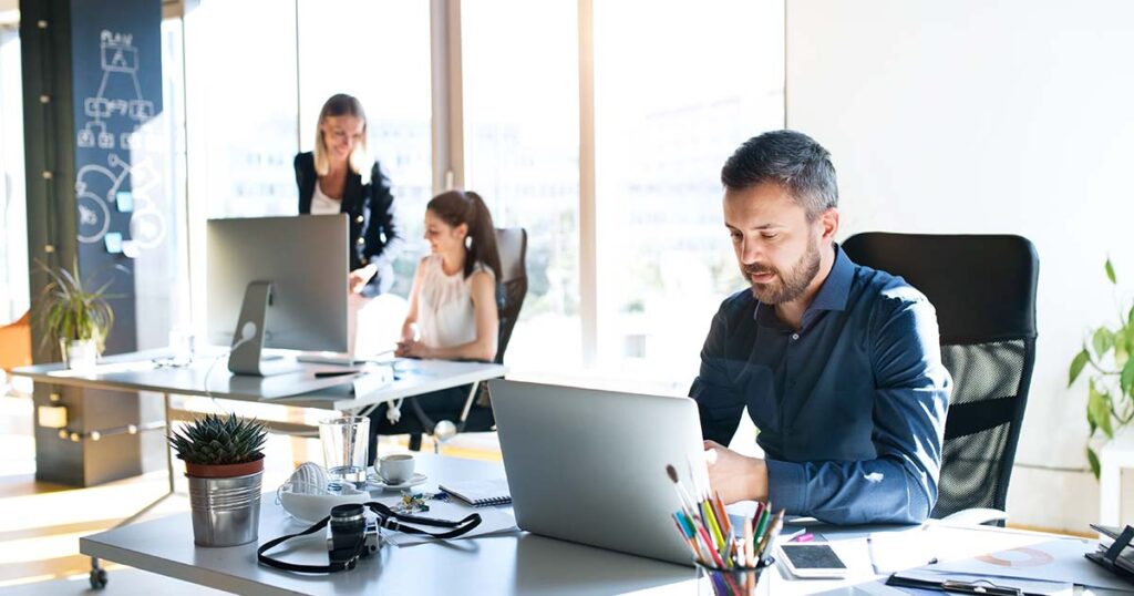 Employee reviewing benefits at his desk