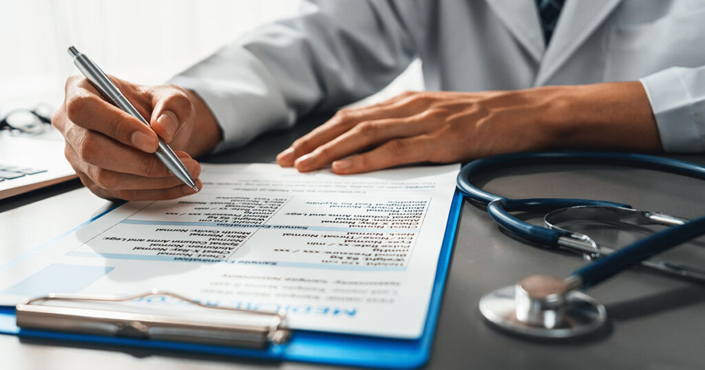 Doctor writing note for employee sick leave