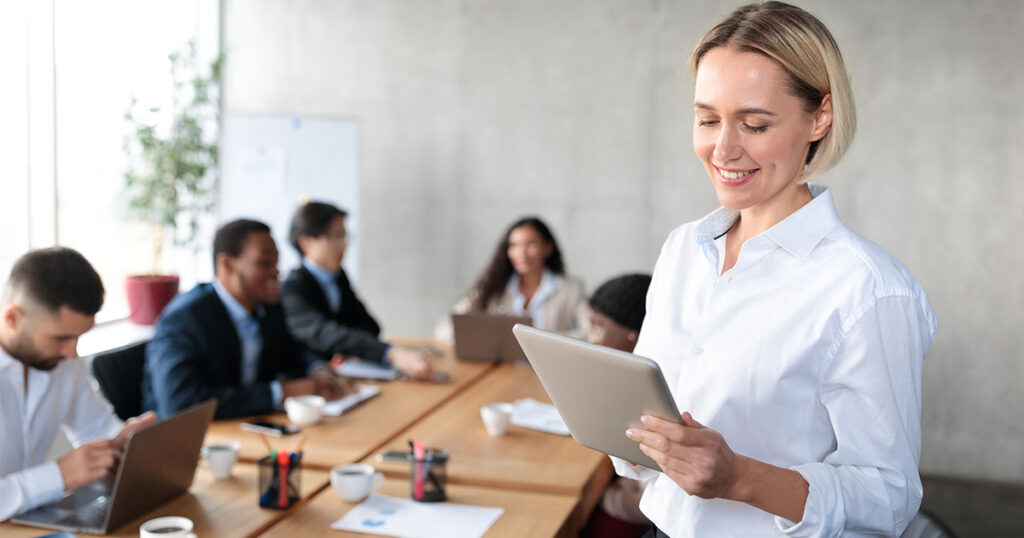 Business owner utilizing technology during a work meeting
