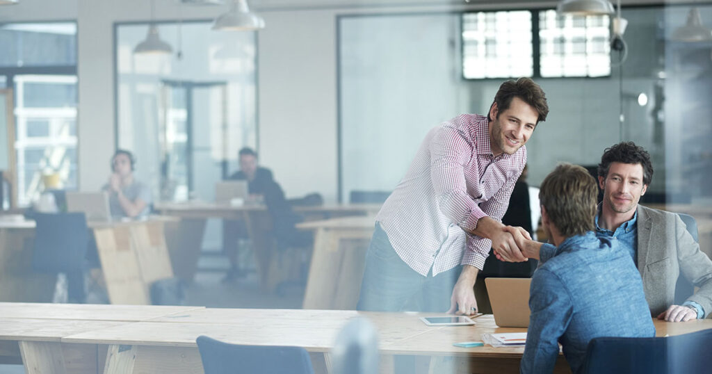 Sales team closing deal with another business using education-based selling