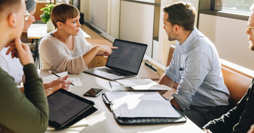 HR team looks at open enrollment data at review meeting