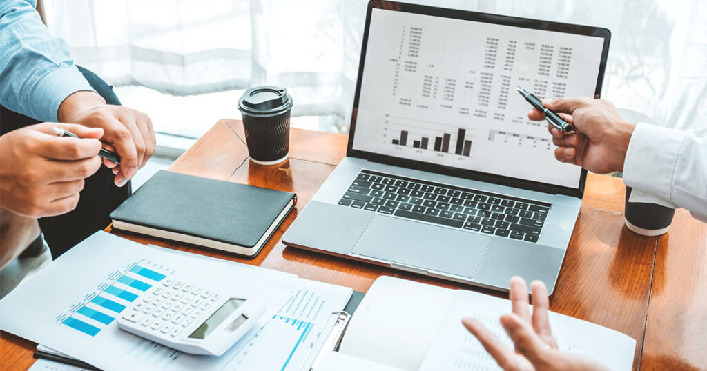 Accounting team using its accounting software to review and generate reports in a meeting