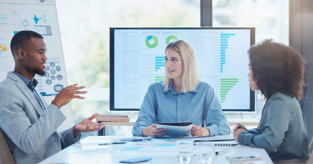 Business team going over data findings in a meeting to inform future strategies