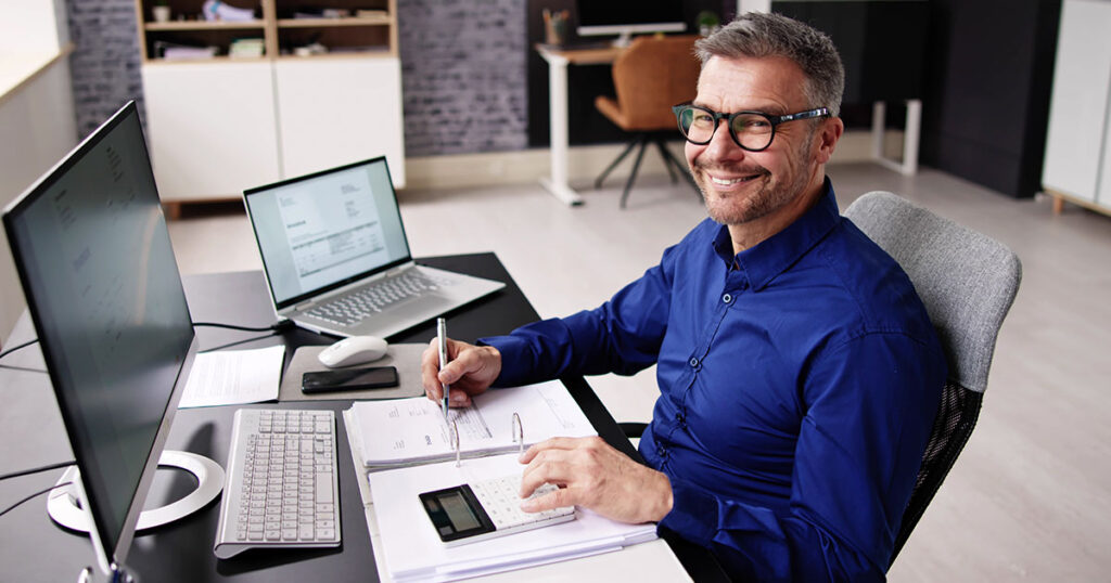 CPA working at a desk going through a business's financials