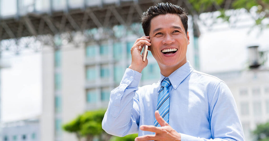 Joyful businessman talks on the phone