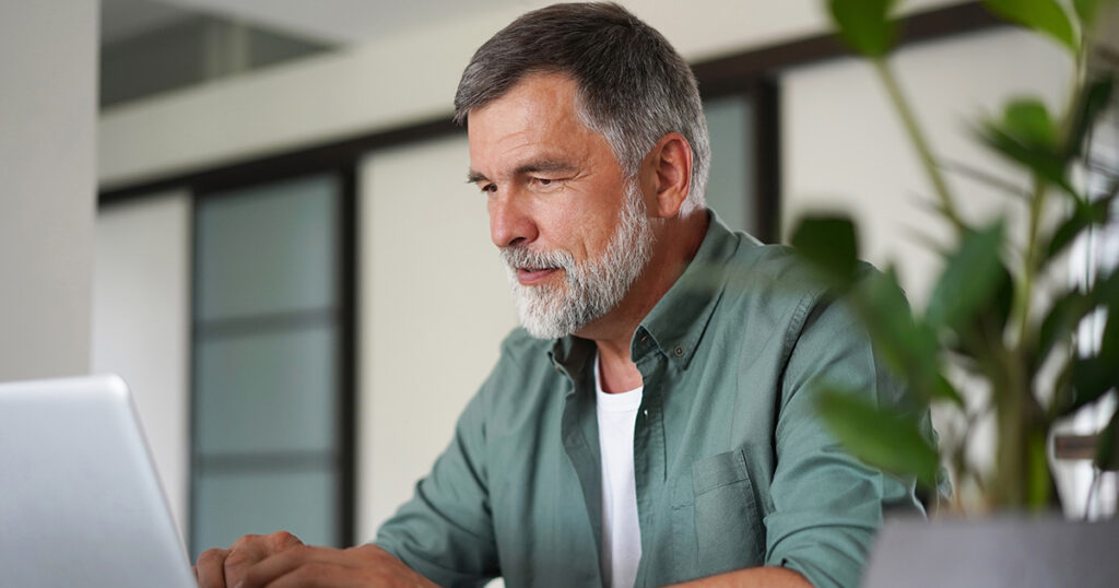Man researches how to prepare finances for a natural disaster