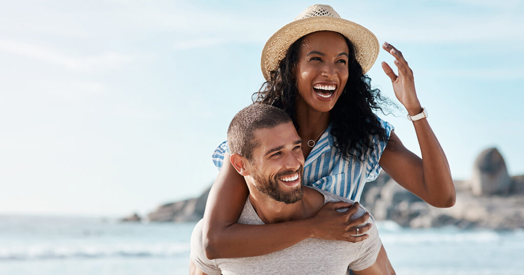 Happy couple enjoys summer at the beach