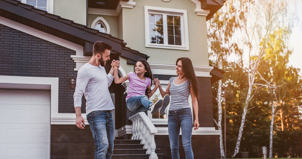 Happy family spends time outside their home