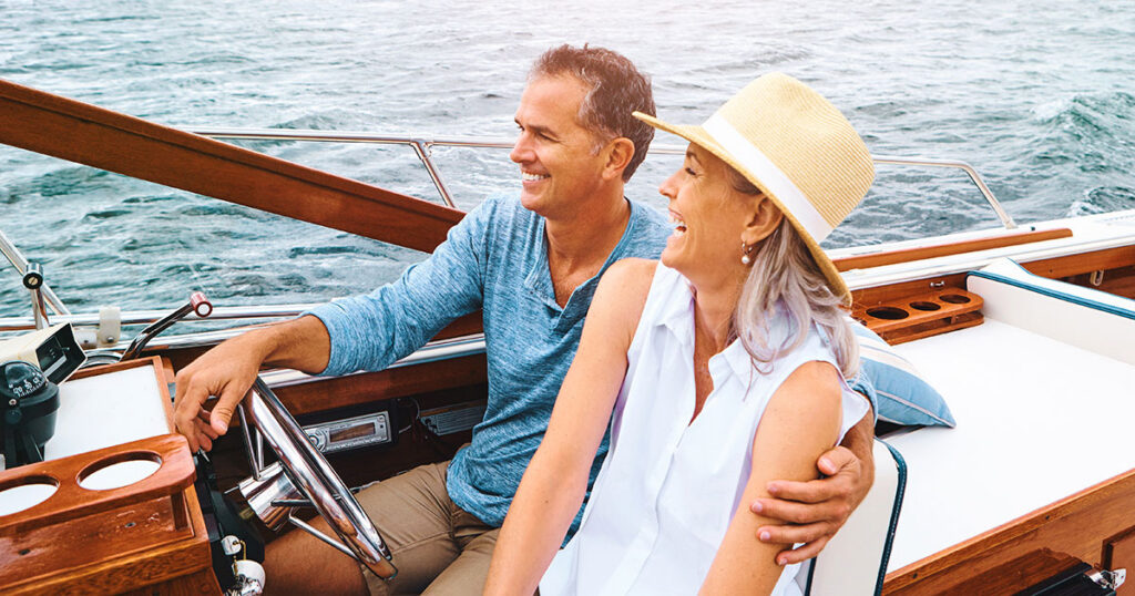 High-net-worth couple on a boat discussing insurance and wealth protection planning