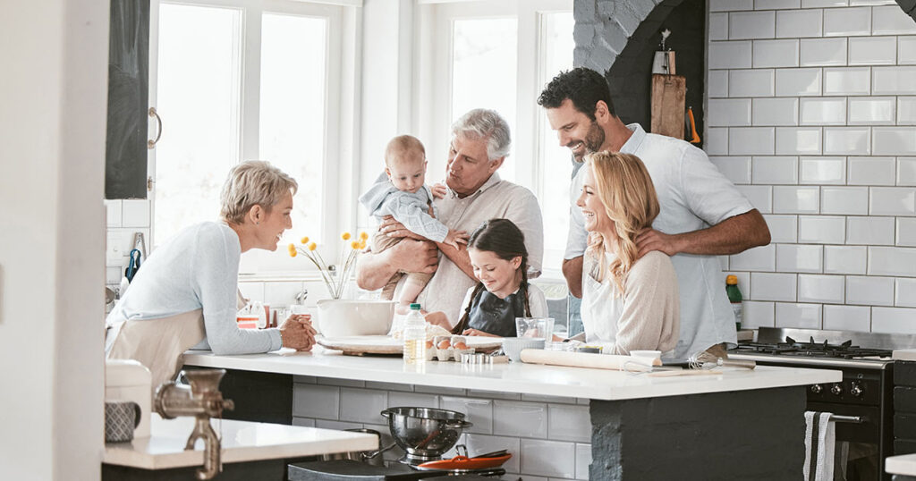 Multigenerational family spending time together in a kitchen, symbolizing tax-efficient wealth transfer across generations