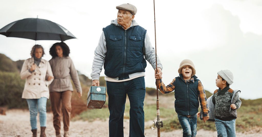 Multigenerational family walking together on a beach for a fishing trip, representing how thoughtful family wealth planning can create shared experiences and lasting memories across generations
