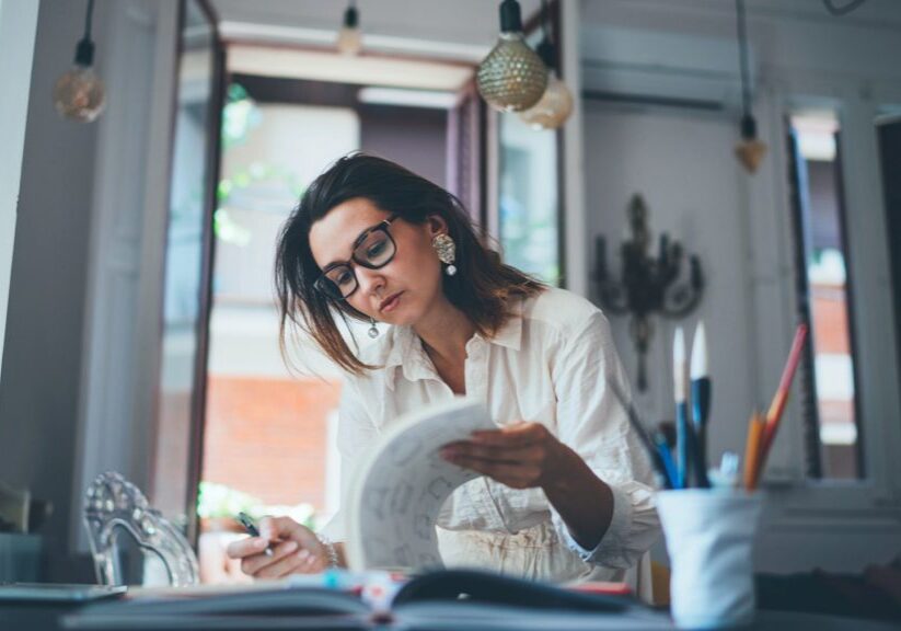 Woman reviewing documents in binder