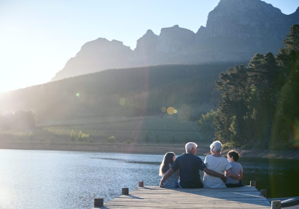Family sitting on dock looking at beautiful views