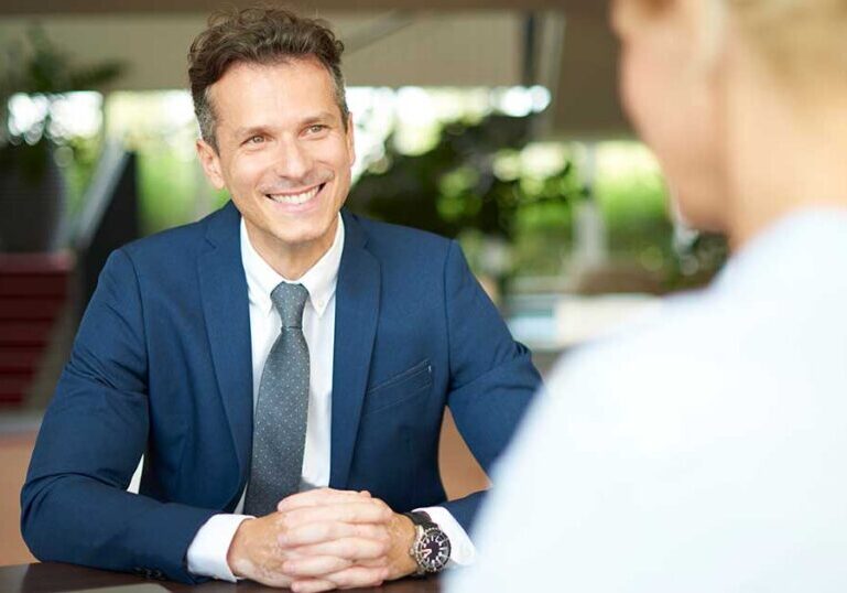 Wealth advisor meeting with a client to discuss legal asset protection strategies to help safeguard family wealth from lawsuits and creditors