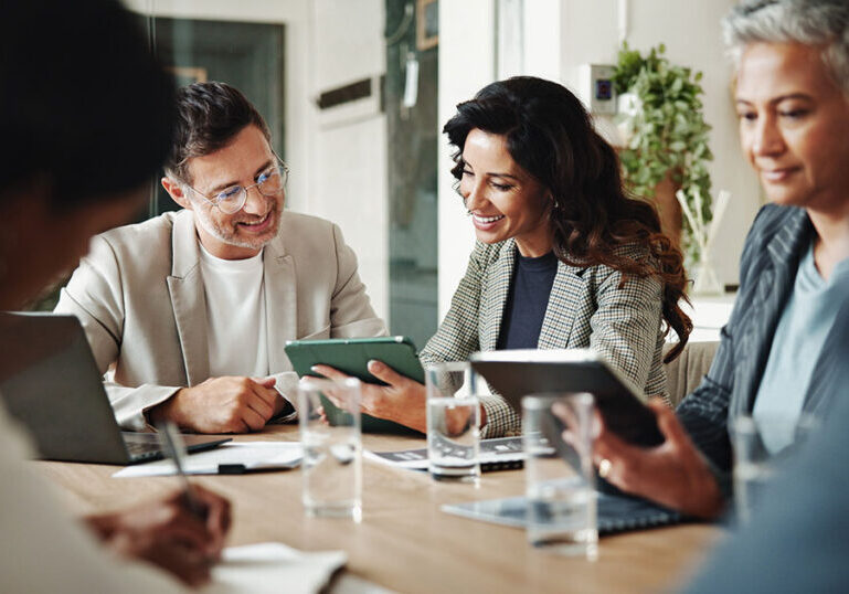 Multi-generational family office team reviewing tax and investment documents together at a conference table