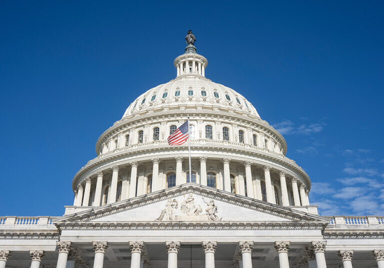 The United States Capitol dome against a clearing blue sky viewe