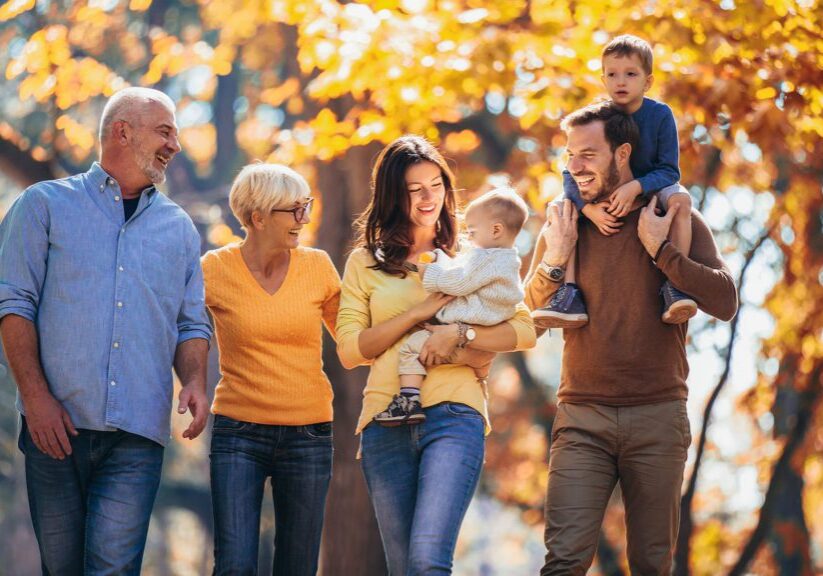 Multl generation family in autumn park having fun