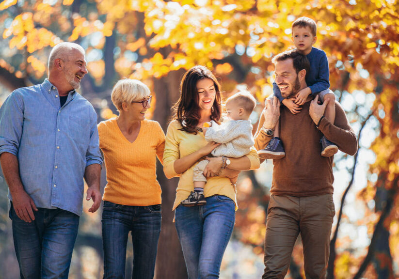 Multl generation family in autumn park having fun