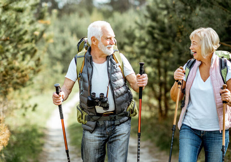 Senior couple talks about tax-loss harvesting while on hike