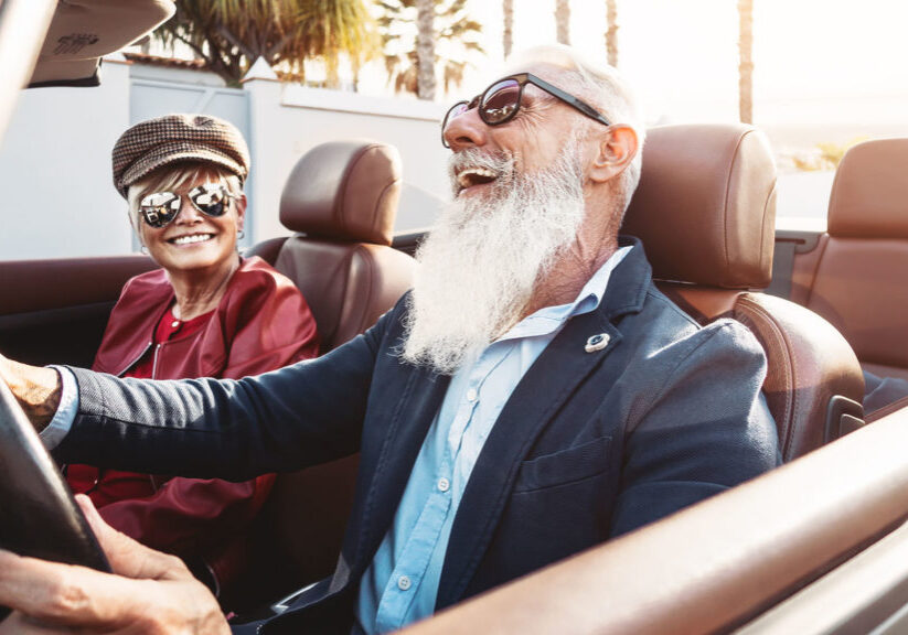 Happy senior couple having fun in convertible car