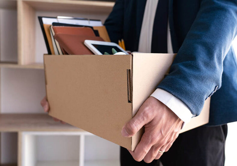 A man packs up his desk as he changes employers