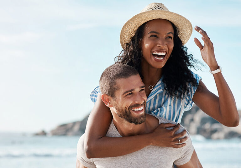 Happy couple enjoys summer at the beach